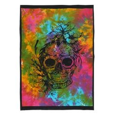 a colorful tie dye skull with flowers on it