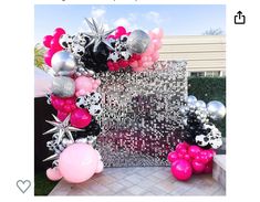 the balloon arch is decorated with pink, silver and black balloons