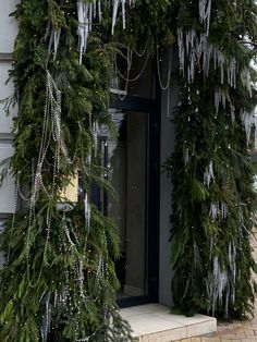 christmas decorations are hanging from the side of a building