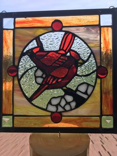 a stained glass window with a bird on it