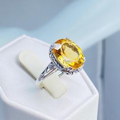 Natural Yellow Citrine Ring  Edward Design#70z (10x12 version) Custom/Made to Order Here we have an Edwardian reproduction ring in sterling silver filigree with a lovely Natural genuine 3.3ct Yellow Citrine gemstone solitaire. This full cut oval gem is 12mm in length and 10mm in width. This ring also sits 7mm off the finger. The inside of the band is marked 925 for sterling silver. Notice the beautiful leaf design of the silver filigree setting and etched band. This is a lovely rendition of an A Oval Citrine Topaz Ring In White Gold, Yellow Oval Topaz Ring With Accent Stones, Oval Yellow Topaz Ring With Accent Stones, Yellow Oval Topaz Rings, Yellow Oval Topaz Ring With Center Stone, Yellow Oval Topaz Ring Hallmarked, Yellow Oval Gemstones With Accent Stones, Classic Oval Citrine Gemstones, Yellow Oval Birthstone Ring