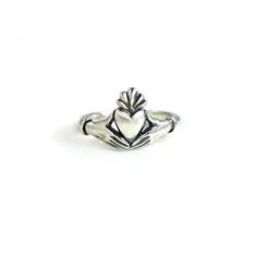 This Claddagh Ring in sterling silver is an original design for my friend Lily's wedding ring. I liked it so much I decided to offer it to others. It is a delicate rendition of the traditional claddagh ring with delicate, feminine hands and wrists. Each wrist wears a single bracelet, opposed to the usual cuff. The hands are fully 3D, and hold the edges of the heart in a realistic way. Oxidized in the crevices to bring out the details, and highly polished throughout. The band measures approximate Symbolic Sterling Silver Stackable Promise Rings, Classic Sterling Silver Open Heart Ring, Classic Sterling Silver Hand Cast Rings, Classic Hand Cast Sterling Silver Rings, Sterling Silver Heart Promise Ring, Sterling Silver Heart Ring With Polished Finish For Promise, Heirloom Style Sterling Silver Stackable Rings With Polished Finish, Heirloom Sterling Silver Stackable Rings With Polished Finish, Heirloom Sterling Silver Stackable Open Rings