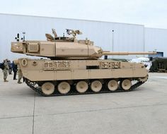 an army tank parked in front of a building