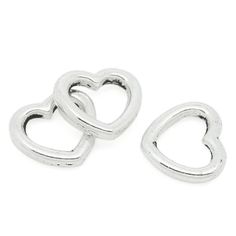 two silver heart shaped charms on a white background