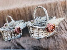 two baskets with flowers are sitting on a table