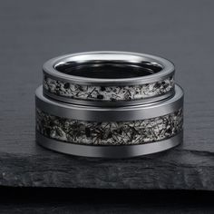 two wedding bands with black and white flowers on them