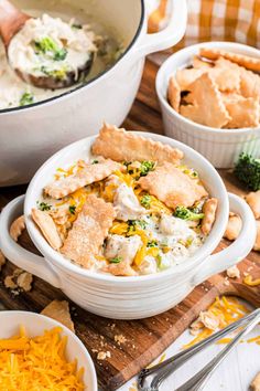 two white bowls filled with chicken and broccoli casserole on a cutting board