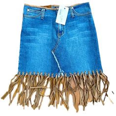 a blue jean skirt with fringes on it