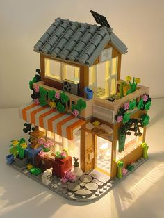 a toy house made out of legos on a table