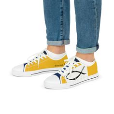 a person wearing yellow and white sneakers