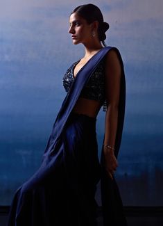 Elevate your evening wear with a stunning Midnight Blue Silk Drape Saree. Crafted from luxurious silk, the deep, rich hue of the saree contrasts elegantly with the intricate detailing on the blouse. The beautifully embroidered blouse is adorned with tonal sequins, crystals, and bugle beads, adding a touch of sparkle and sophistication. Ideal for Mehendi, Sangeet nights or wedding guest attire. Composition : Saree and Blouse - Silk Care: Dry Clean Only and Vacuum Storage This product can be customized for sleeves, length and colour Delivery : 6-8 weeks as the product is hand crafted. Check Size Guide or choose MySize for free customisation (All Sizes above XL can be made at 15% additional cost) For more information and sizes please contact fabiliciousfashion@gmail.com or visit our Copenhage Elegant Silk Pre-draped Saree For Festive Occasions, Silk Pre-draped Saree With Dupatta For Party, Traditional Evening Sets In Tissue Silk, Traditional Tissue Silk Evening Set, Traditional Evening Tissue Silk Sets, Evening Traditional Wear With Resham Embroidery In Tissue Silk, Elegant Evening Pre-draped Saree With Resham Embroidery, Elegant Formal Art Silk Pre-draped Saree, Festive Satin Pre-draped Saree For Formal Occasions