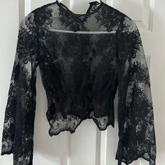 Never Worn Cropped Lace Shirt With Bell Sleeves Black Long Sleeve Lace Top For Summer, Crew Neck Lace Tops For Night Out, Lace Long Sleeve Top For Night Out, Black Lace Top Blouse With Crew Neck, Spring Black Lace Top, Casual Black Lace Top For Party, Black Lace Top For Spring, Casual Lace Top For Party, Sheer Lace Shirt