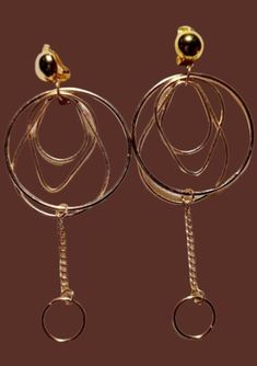 Unique and light light style These hang 4.5 inches Gold metal clip on Multi hoop style  These are very lightweight on the ear Easy to wear Statement style They are one of a kind These Earrings are a classic and timeless addition to any wardrobe Trendy Clip-on Dangle Hoop Earrings, Gold Circle Clip-on Earrings, Elegant Gold Circle Clip-on Earrings, Gold-tone Metal Clip-on Earrings For Party, Modern Gold-tone Metal Clip-on Earrings, Gold Metal Clip-on Hoop Earrings, Gold-tone Metal Dangle Clip-on Earrings, Trendy Dangle Clip-on Hoop Earrings, Gold-tone Drop Clip-on Earrings