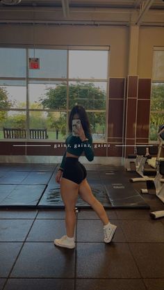 a woman taking a selfie in a gym