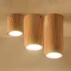 three wooden lights are hanging from the ceiling