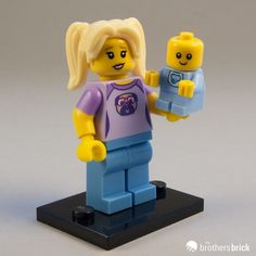 there is a lego girl holding a baby doll