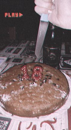 a person cutting into a cake with the number thirteen on it