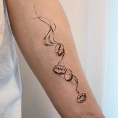 a woman's arm with a tattoo on it that is shaped like a snake