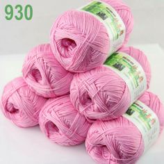 several balls of pink yarn are stacked on top of each other with the price tag