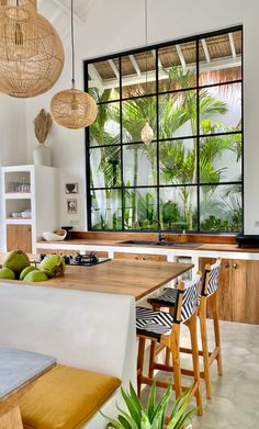 a kitchen with lots of windows and wooden furniture