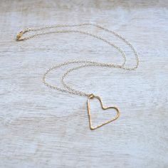 "This gold filled floating heart necklace is so dainty and sweet. It's 1\" in size and hangs from a delicate gold filled cable chain in your choice of 16\" or 18\" lengths. Makes a lovely gift for that someone special. Made from 19g gold filled wire and hammered to give it a slight glimmer." Delicate Open Heart Charm Necklace With Delicate Chain, 14k Gold-filled Heart Necklace With Adjustable Chain, Everyday 14k Gold Filled Heart Necklace With Delicate Chain, Delicate Open Heart Necklace With Delicate Chain, Delicate Open Heart Chain Necklace, Gold Open Heart Charm Necklace, Delicate 14k Gold Filled Heart Necklace For Valentine's Day, Delicate 14k Gold Filled Heart Pendant Charm Necklace, Gold Heart-shaped Jewelry For Bridesmaid Gift