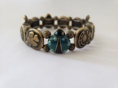 This whimsical piece radiates good luck and features enamel turtles, clovers, and horseshoes. Whether you're a fan of vintage treasures or simply love unique jewelry, this bracelet will become a favorite in your collection! - Stretch Bracelet - One of a kind - Vintage 1990s - Great condition! Adjustable Vintage Bronze Beaded Bracelets, Adjustable Retro Nickel-free Jewelry, Bohemian Adjustable Bracelets With Vintage Charm, Adjustable Enamel Charm Bracelet As Gift, Adjustable Enamel Charm Bracelet Gift, Adjustable Enamel Charm Bracelet For Gift, Adjustable Bohemian Bracelet With Vintage Charm, Adjustable Bohemian Bracelets With Vintage Charm, Vintage Adjustable Beaded Bracelets With Charms