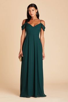 a woman in a long green dress with one shoulder open and the other half closed