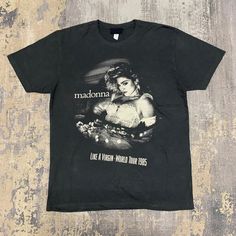 a black t - shirt with the words madonna on it and a woman's face