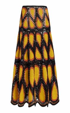 a black and yellow skirt with orange circles on the bottom, in front of a white background