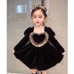 This luxurious dress exudes elegance and sophistication. The square neckline and ruffled sleeves create a charming and feminine look, while the heart-shaped design adds a touch of sweetness. Made with high-quality fabric, this black dress is perfect for your little princess's special occasions. COLOR Black GENDER Baby Girl, Girl MATERIAL Polyester PATTERN Heart SEASON Spring, Autumn SIZE (AGE) 90 (12-24M), 100 (2-3Y), 110 (3-5Y), 120 (5-7Y), 130 (7-8Y), 140 (8-10Y) Black Princess Dress, Baby Girls Dress, Luxurious Dresses, Black Princess, Princess Skirt, Ruffled Sleeves, Feminine Look