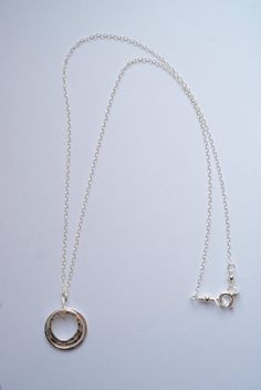 This lovely necklace will bring a simple style and elegance to any outfit. Three circles necklace, each circle is a different size. One circle is slightly large then the next. These circles are hand formed and then fused together. The smallest and middle sized circles are hammered to bring a shimmer to the charm - the largest of the three circles is a flat finish. Each circle is made from a heavy gauge fine silver (99.9% silver). The pendant measures about 1 inch. The necklace is a sterling silv Silver Open Circle Necklace, Sterling Silver Round Disc Delicate Jewelry, Sterling Silver Delicate Round Disc Jewelry, Circle Sterling Silver Necklace In White Gold, Delicate Sterling Silver Round Disc Jewelry, Sterling Silver Necklace With Round Pendant, White Gold Sterling Silver Circle Necklace, Sterling Silver Cable Chain Charm Necklace For Anniversary, Sterling Silver Charm Necklace With Cable Chain For Anniversary