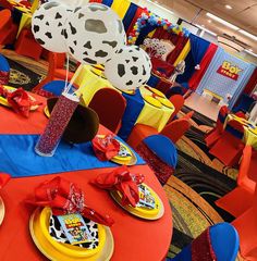 the tables are decorated with red, yellow and blue decorations