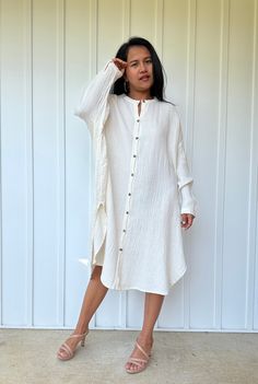 Relax in style with the Aura shirtdress, a unique take on traditional loungewear. Made from breathable double gauze cotton, it's perfect for casual wear out, at home, or even as a beach coverup. The button-down design adds a touch of style and versatility to your wardrobe, ensuring comfort and convenience as you go about your day. Long Cotton Shirt Dress For Vacation, Oversized Button-up Shirt Dress For Beach, Chic Cotton Shirt Dress For Beach, Chic Linen Button-up Dress For The Beach, Chic Cotton Shirt Dress For The Beach, Chic Button-up Linen Dress For The Beach, Summer Cotton Tunic Shirt Dress, White Linen Shirt Dress For Beach, Long Sleeve Cotton Shirt Dress For Beach