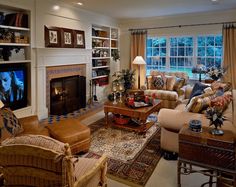 a living room filled with furniture and a flat screen tv mounted to a wall above a fireplace