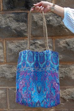 The Pam Printed Jute Bag in Blue Paisley ♡ Product Highlights ♡ Our Pam Printed Jute Bag in Blue Paisley is the perfect bag and unique touch to add to any on-trend bohemian style outfit! As an everyday purse, a trusty beach or pool bag, or even as a travel bag, this Pam Printed Jute Bag in Blue Paisley will be a perfect addition to your closet! ✁ Contents & Measurements ✁ Our Pam Printed Jute Bag in Blue Paisley features: • 100% Polyester fabric • A 17 inch length and a 14 inch width. • 13 inch Blue Tote Hobo Bag For Festivals, Blue Tote Shoulder Bag For Festivals, Blue Rectangular Bags For Festival, Bohemian Blue Hobo Tote Bag, Bohemian Blue Shoulder Bag For Festivals, Bohemian Turquoise Travel Bag, Blue Bohemian Hobo Shoulder Bag, Blue Summer Hobo Tote Bag, Blue Bohemian Hobo Bag For Everyday Use