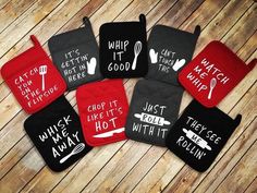 six oven mitts with sayings on them sitting on a wooden floor next to each other