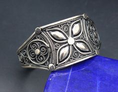 "Magnificent! I am offering you Moroccan traditional sterling silver cuff bracelet. Its 100% hand crafted workmanship with beautiful carve design. This bracelet can perfectly adjust to your wrist. Please do not hesitate to contact if you have any questions about items or further informations, Measures : Opening Of the Mouth : Inches 1.2\" ( 3cm ) ( Adjustable ) Inner circumference : Inches 6.4\" ( 16.2 cm ) ( Adjustable ) Width : Inches 1.2\" ( 3 cm ) The weight : 28.1 grams, You will get all th Carved Sterling Silver Bracelet As Gift, Handmade Sterling Silver Ornate Cuff Bracelet, Handmade Ornate Sterling Silver Cuff Bracelet, Ornate Handmade Sterling Silver Cuff Bracelet, Cosmic Ring, Carved Designs, Sterling Silver Cuff Bracelet, Unique Bracelets, Jewelry Photography