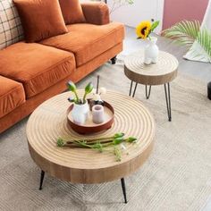 a living room filled with furniture and flowers in vases on top of coffee tables