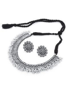 This jewellery set consists of a necklace, a pair of earrings, a finger ring and a nose pin Oxidised silver-plated choker necklace, has intricate textured detailing and bead droplets, secured with a drawstring closure A pair of matching stud earrings, secured with post-and-back closure Oxidised silver-plated adjustable finger ring, has a floral-shaped design motif Oxidised silver-plated nose pin with clip-on closure Size & Fit Necklace length: 42 cm Necklace width: 3 cm Earring length: 2.8 cm each Nose pin length: 1.7 cm Ring dimension: Adjustable Material & Care Material: German silver Plating: Oxidized silver-plated Care Instructions: Wipe your jewellery with a soft cloth after every use Always store your jewellery in a flat box to avoid accidental scratches Keep sprays and perfumes away Silver Pendant Jewelry Sets For Festive Occasions, Festive Silver Pendant Jewelry Sets, Silver Hand Set Pendant Jewelry Sets, Silver Jewelry Sets With Oxidized Finish Pendant, Festive Temple Jewelry In Silver, Silver Temple Jewelry Sets For Gift, Silver Temple Jewelry Choker Set, Temple Jewelry Sets In Silver, Perfect For Gifts, Silver Temple Jewelry Sets