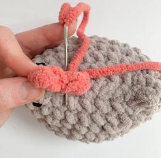 someone is crocheting the yarn on top of an object with scissors in it