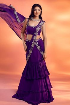 Purple pre-draped layered lehenga saree, with attached cancan, silver floral embroidery on the drape. Comes with floral embroidered padded blouse.
Components: 2
Pattern: Embroidered
Type Of Work: Floral
Neckline: Square
Sleeve Type: Sleeveless
Fabric: Georgette
Color: Purple
Other Details: 
Attached lining
Approx. product weight: 1-2 Kgs
Occasion: Destination Wedding - Aza Fashions Drape Lehenga, Layered Lehenga, Sari Lehenga, Lehenga Designs Simple, Gaun Fashion, Saree Designs Party Wear, Indian Dresses Traditional, Traditional Indian Outfits, Indian Gowns Dresses