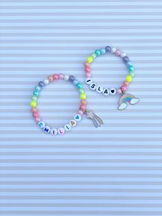 Adorable kids beaded bracelet with 6mm pastel iridescent rainbow beads with your choice of name/lettering and charm. Charms available currently are shooting star and rainbow. So cute and the charm adds such a unique look to your little one's bracelet! Makes a great gift as well- everyone loves something personalized! Please provide the following information in the personalization field: -Name/word you would like -Heart color (if any)- red, orange, yellow, green, blue, purple, pink, black or gold Personalized Rainbow Beaded Bracelets For Birthday, Personalized Rainbow Beaded Bracelet For Birthday, Playful Rainbow Beaded Bracelets For Birthday, Personalized Cute Rainbow Bracelets, Cute Personalized Rainbow Bracelets, Personalized Multicolor Charm Bracelet For Birthday, Cute Personalized Multicolor Beaded Bracelets, Playful Rainbow Adjustable Charm Bracelet, Personalized Rainbow Beaded Bracelets Cute Style