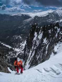 a man standing on top of a snow covered mountain