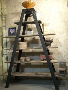 an old wooden shelf with baskets on top and other items in the bottom tiers