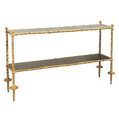 a gold and black shelf with candles on it