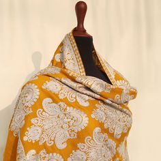 Mustard Embroidered Kashmiri pashmina kashmiri wool shawl with vibrant paisley embroidered motifs across the entire shawl. Embellished with regal embroidery. Perfect for formal occasions to add a pop of color to your outfits. These medium-length shawls are the perfect length to be styled with both eastern and western outfits. Dazzle up your wardrobe with a uniquely crafted fully embroidery shawl. Product specifications: Base color: Mustard Material: 100% Pashmina wool Washing instructions: Hand wash in cold water Dimensions:200cm by 70cm Shipping details: The product will be delivered to you between 5-10 working days. 1-2 days processing time for all orders. Now offering free shipping to your doorstep! Festive Embroidered Jacquard Dupatta, Raw Silk Pashmina Shawl With Motifs, Traditional Raw Silk Pashmina Shawl With Motifs, Traditional Drape Raw Silk Pashmina Shawl With Motifs, Traditional Embroidered Jacquard Dupatta, Jamawar Pashmina Shawl With Zari Work, Elegant Jacquard Dupatta For Eid, Gold Wedding Shawl With Motifs, Wedding Gold Shawl With Motifs