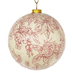 a red and white ornament with flowers on it