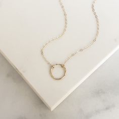 Your favorite new everyday necklace. The Full Circle necklace features a lightly hammered sterling silver or 14k gold fill circle suspended on an adjustable drop chain adored with delicate heart charm. Simple Adjustable Charm Necklace For Everyday, Everyday Circle Charm Necklaces With Adjustable Chain, Dainty Hammered Charm Necklaces For Everyday, Everyday Minimalist Hammered Charm Necklaces, Everyday Hammered 14k Gold Filled Necklace, Adjustable Circle Necklaces For Everyday, Everyday Adjustable Circular Necklaces, Hammered Round Necklaces For Everyday, Dainty Open Circle Charm Necklaces For Everyday