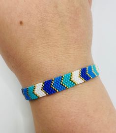 - Handmade beaded blue colors minimalist chevron bracelet - Miyuki seed beads, gold beads are 24K gold plated - The length of bracelet is 17,5 cm extended 5 cm, bracelet width 0.8 cm - The length of bracelet is 6,88 inches extended 1,96 inches, bracelet width is 0,31 inches JEWELRY CARE - Keep jewelry dry - Take it off before taking shower, bath, swimming or exercising - Makeup, perfume, hairspray apply before wearing jewelry - Store your jewelry somewhere dry, not in the bathroom Handmade in Cy Minimalist Blue Friendship Bracelets With Colorful Beads, Blue Beaded Minimalist Friendship Bracelets, Minimalist Handmade Blue Friendship Bracelets, Blue Chevron Bracelet, Bracelet Chevron, Chevron Bracelet, Blue Chevron, Handmade Bracelet, Keep Jewelry