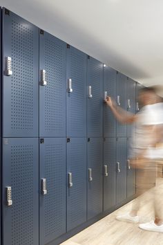 a blurry photo of a person standing in front of lockers